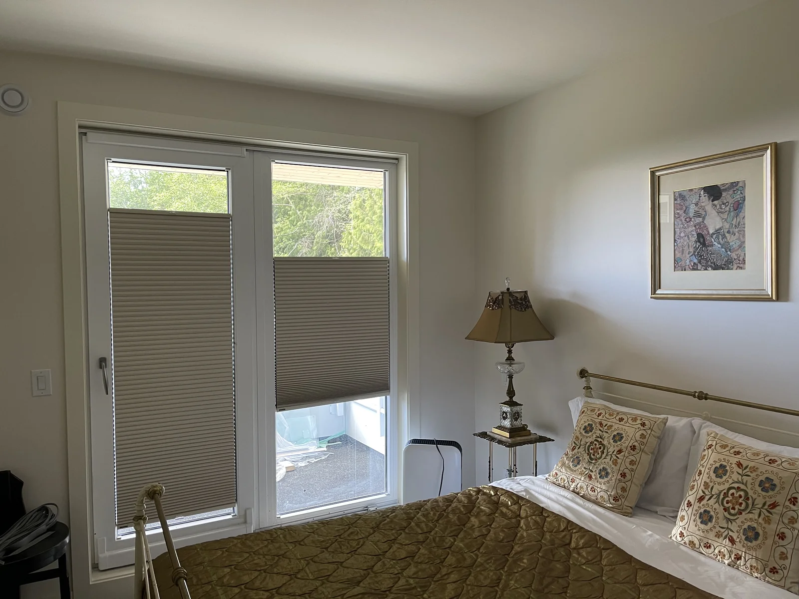 Taupe cellular shades at two glazed bedroom doors, with daylight above the lowered top rails
