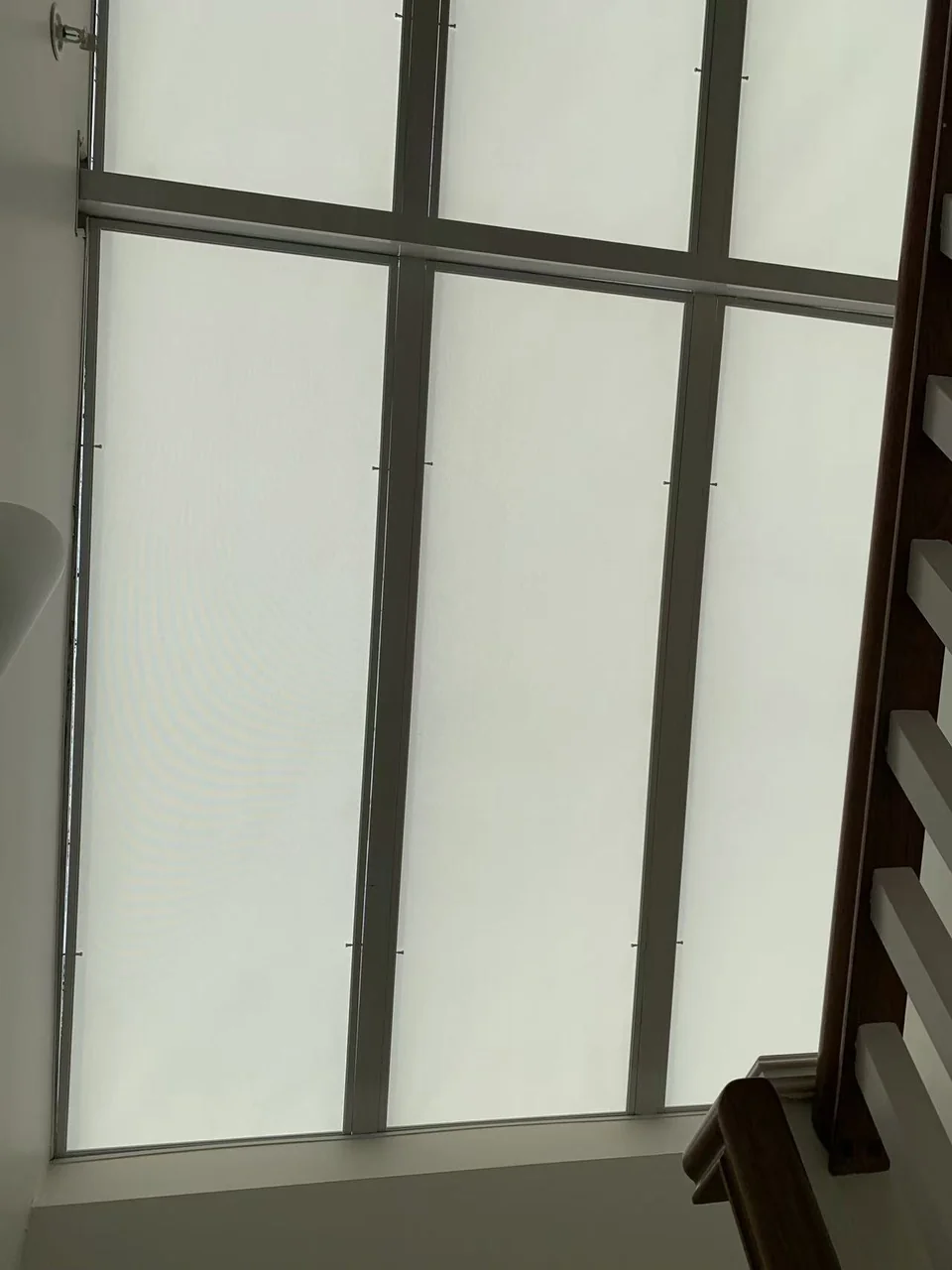 Light-coloured shading panels within the divisions of a glazed roof